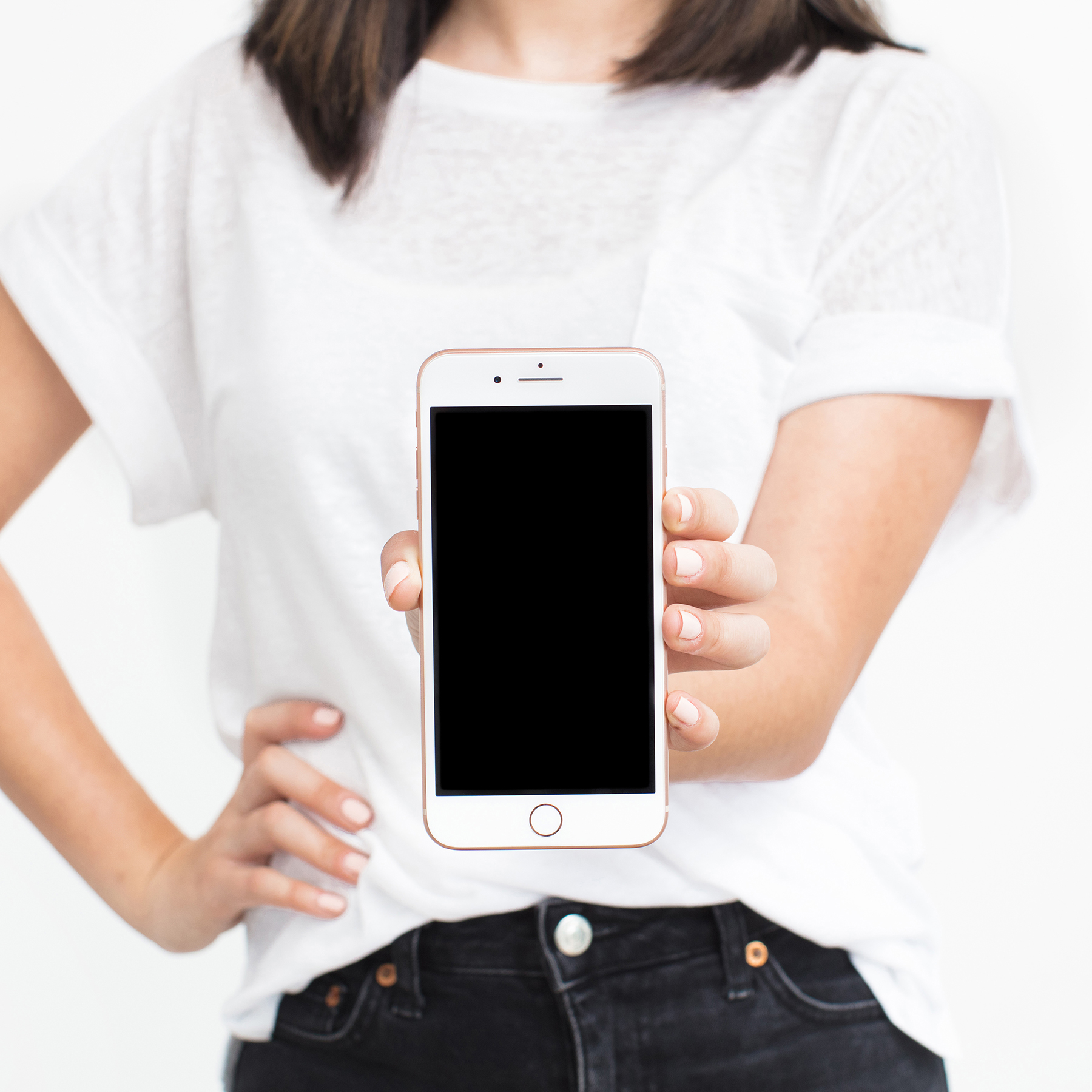 A woman holding out a mobile phone to demonstrate her newly launched digital product